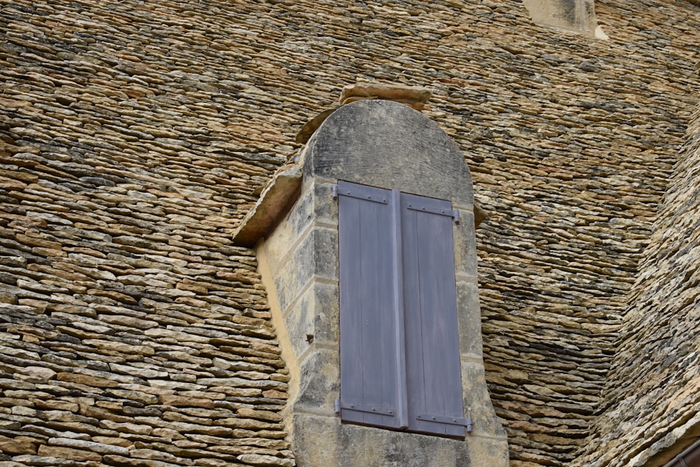 low-angle photography of closed gray wooden window