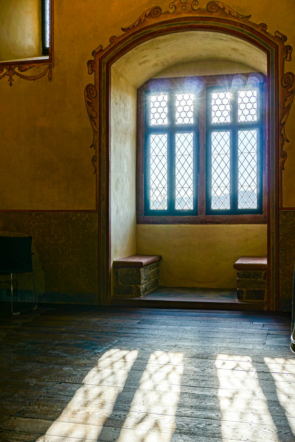 building with benches by the window during day