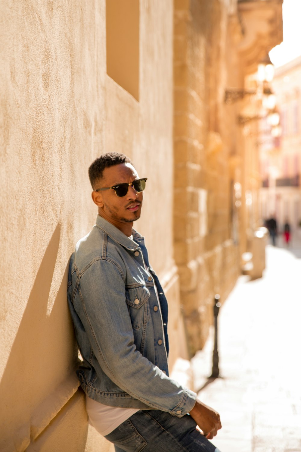 man leaning on wall