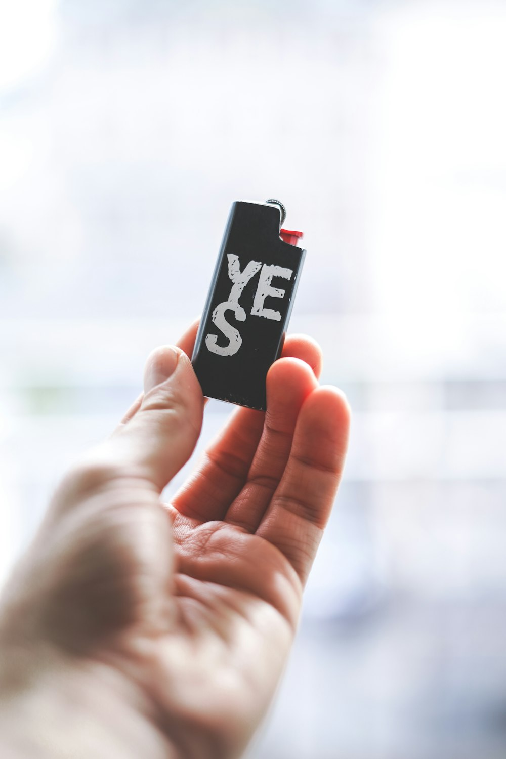 person holding black and white BIC lighter