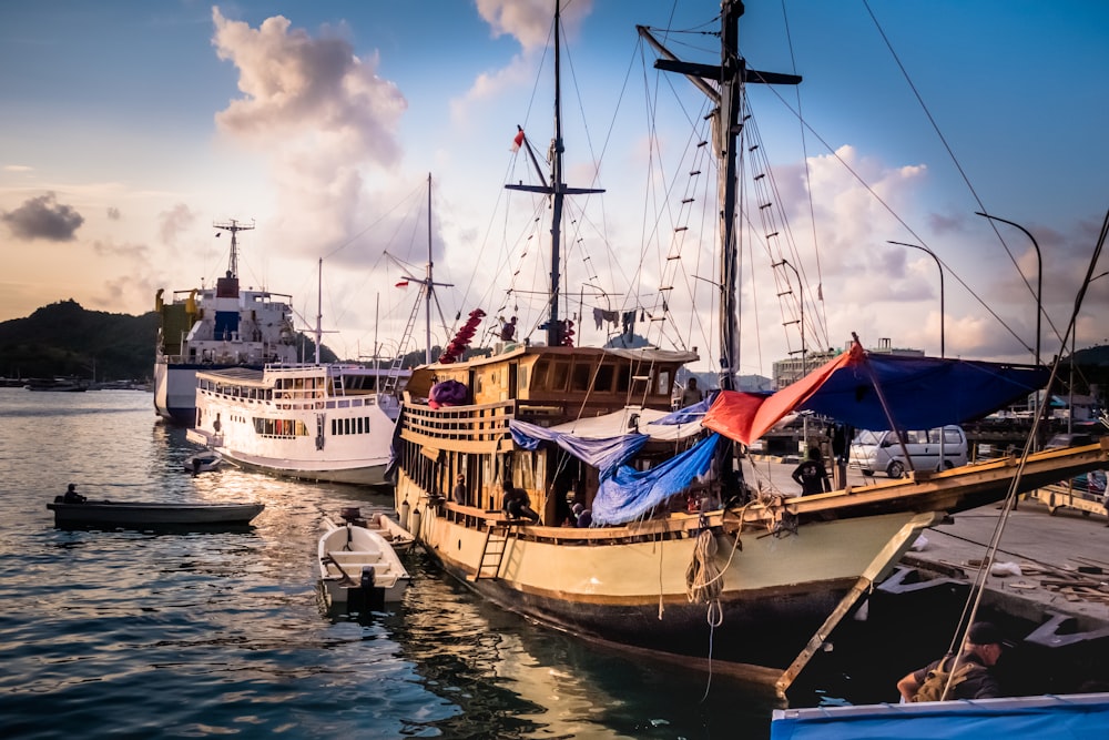 two beige and white boats on body of water