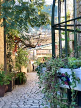 A welcoming garden pathway leading to a cozy outdoor seating area at sunset.