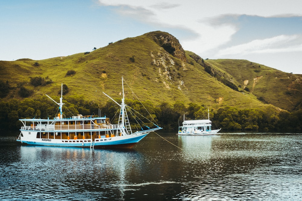 sailing boat near hills