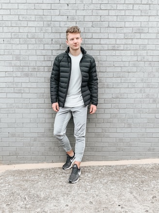 Monochrome streetwear outfit featuring black, white, and gray tones on urban backdrop