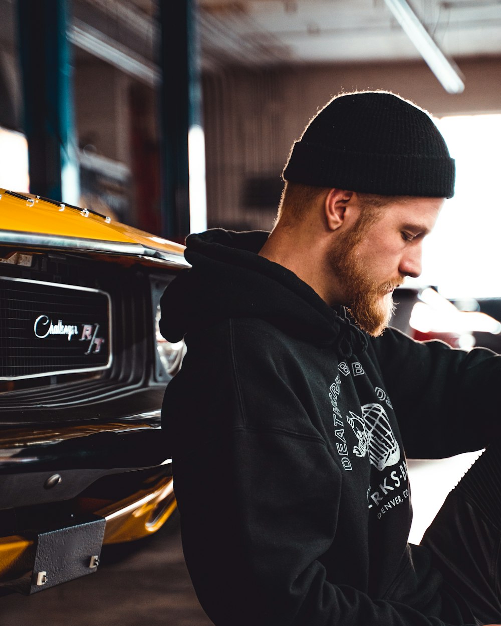 selective focus photography of man standing near vehicle