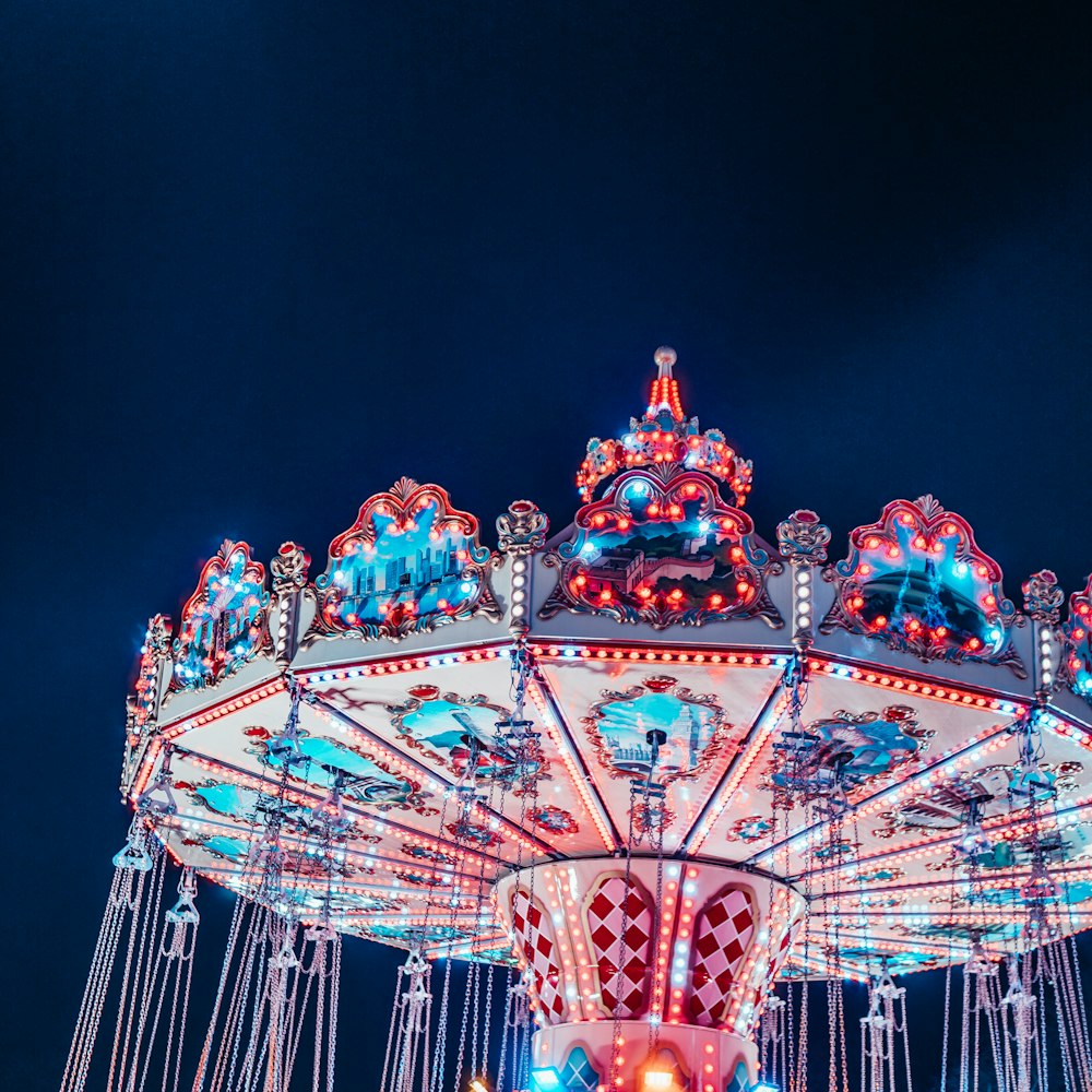 a merry go round at night with lights on