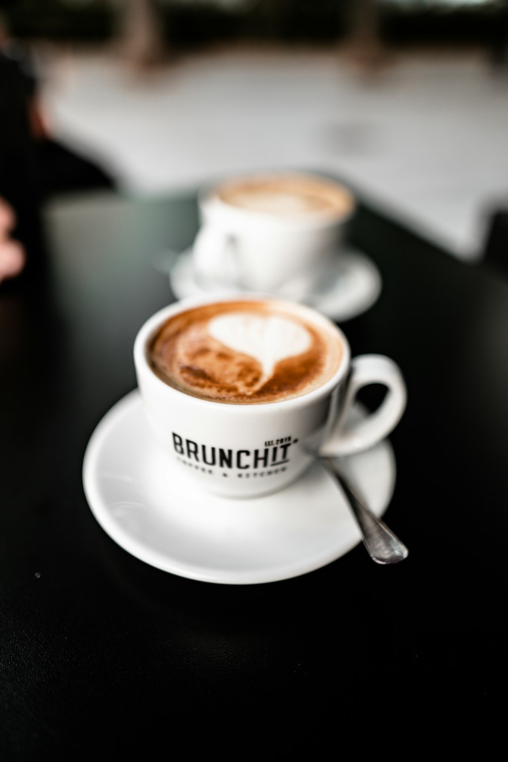 two white ceramic cups on saucers