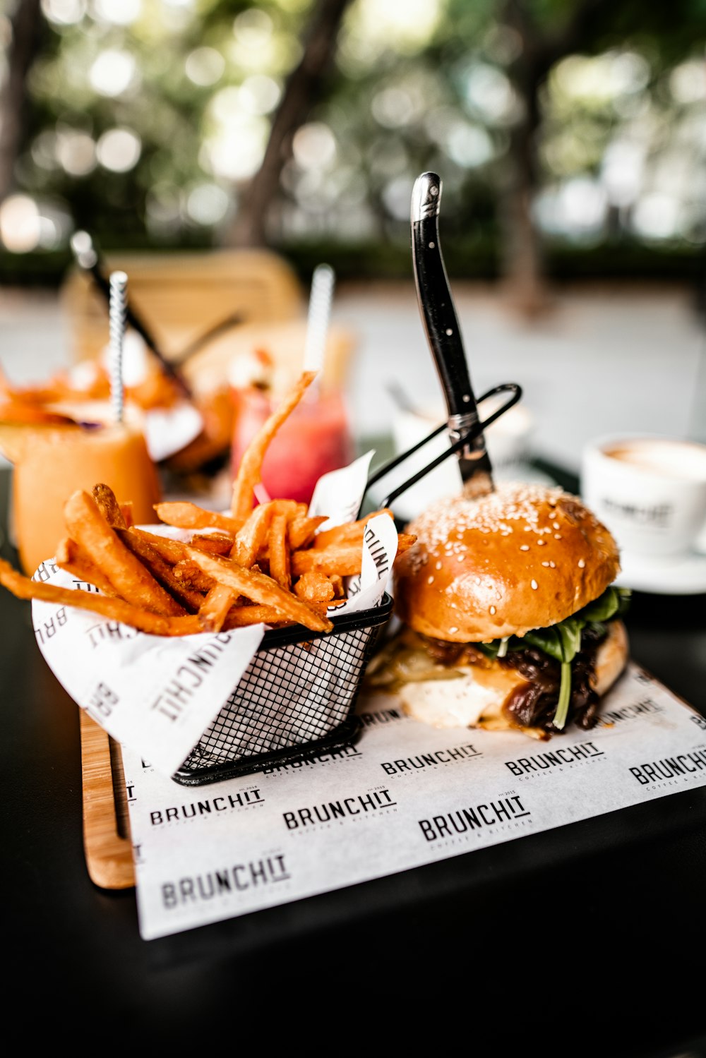 shallow focus photo of French fries beside hamburger