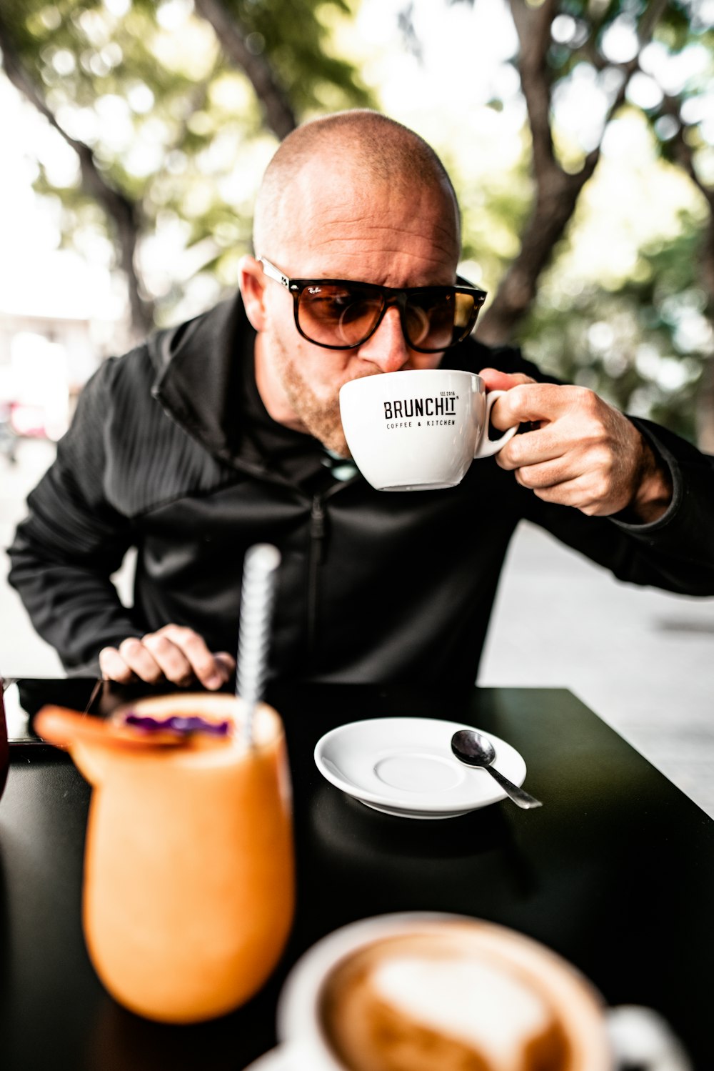 shallow focus photo of man drinking on white ceramic mug