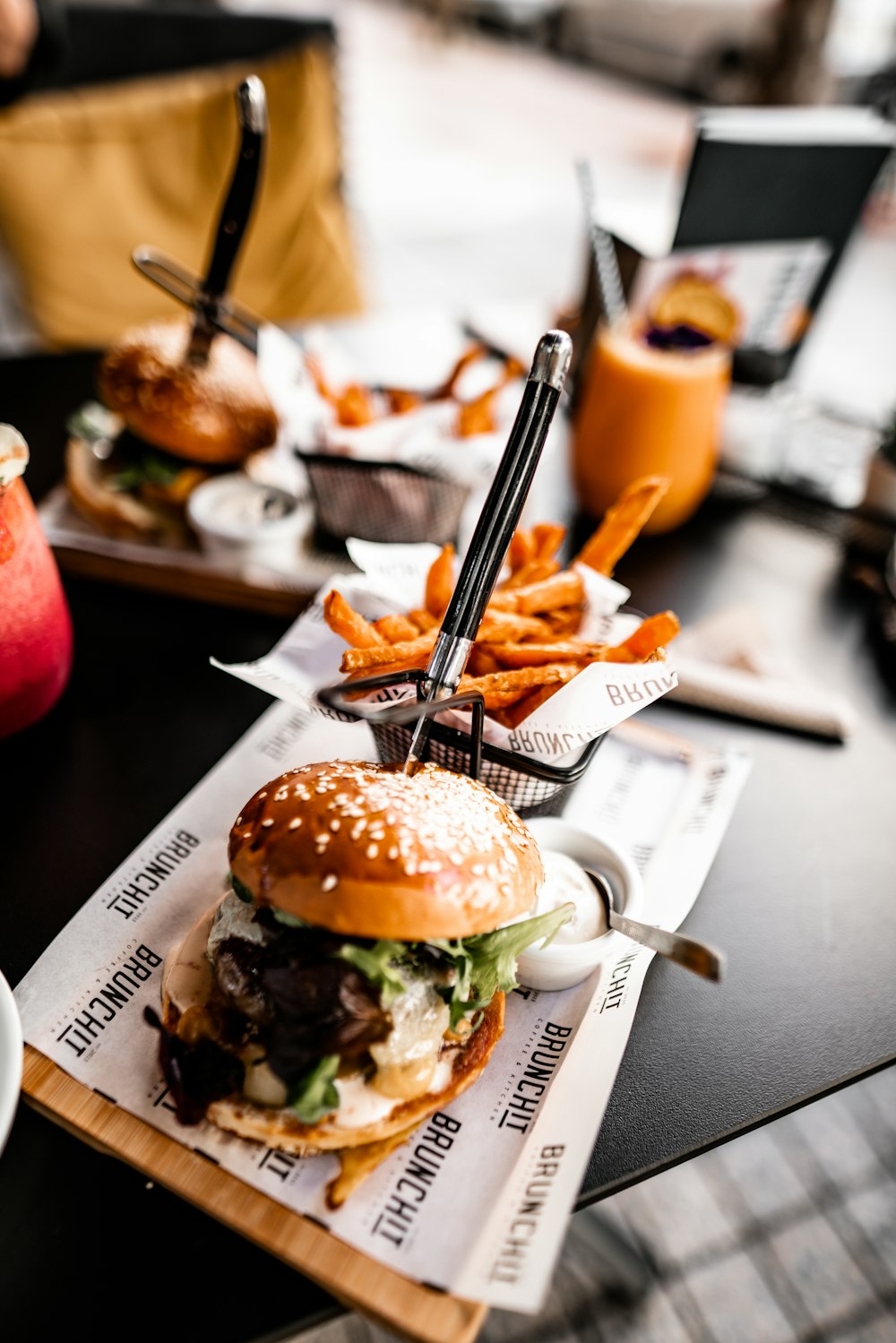 shallow focus photo of hamburger beside French fries