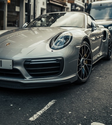 parked gray Porsche Boxster coupe during daytime