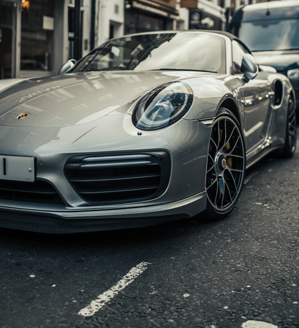 parked gray Porsche Boxster coupe during daytime