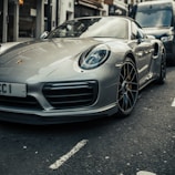 parked gray Porsche Boxster coupe during daytime