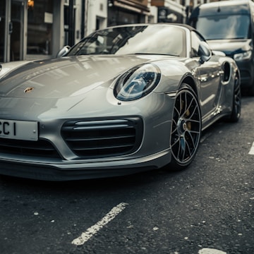 parked gray Porsche Boxster coupe during daytime