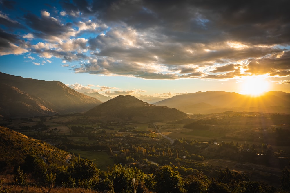 silhouette of mountains under cloudy sky