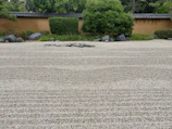 Stone elements arranged in a tranquil Japanese garden setting.