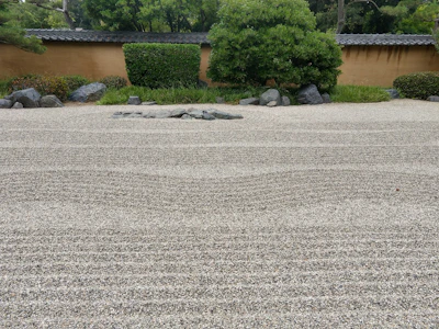 Stone elements arranged in a tranquil Japanese garden setting.