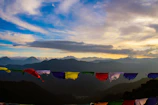 Sunrise view over the misty hills of Mcleodganj with colorful prayer flags fluttering.