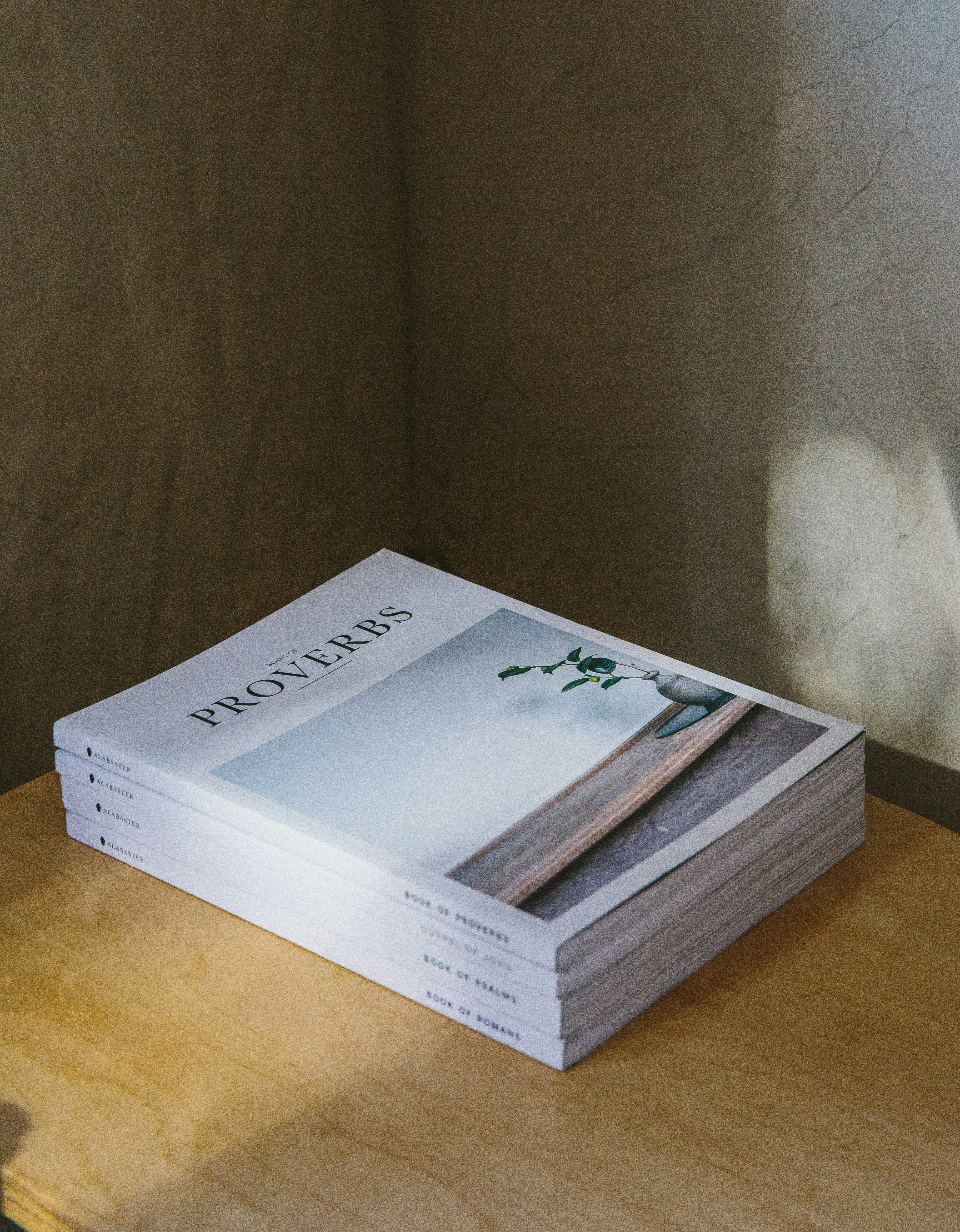 Stack of various gospel-centered resources with soft natural lighting.