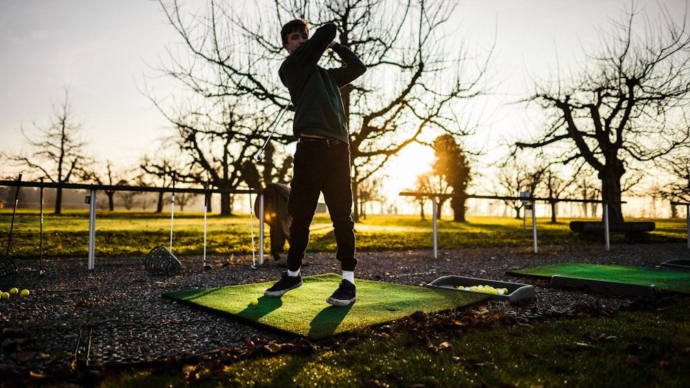 man plays golf at the farm