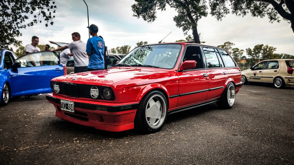 red car parked on concrete pavement