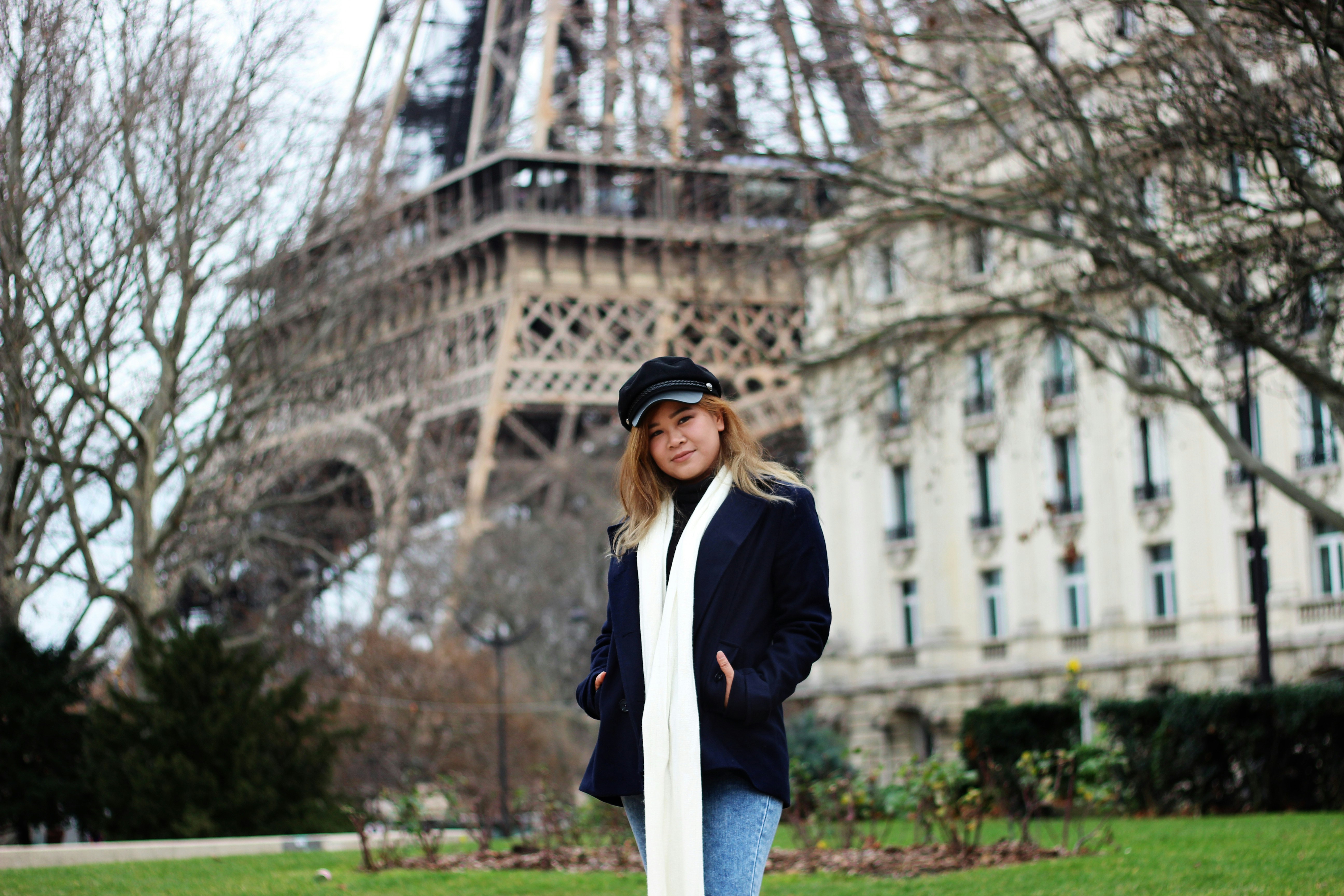 woman wearing white scarf standing on grass field