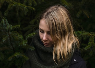 woman standing near pine trees