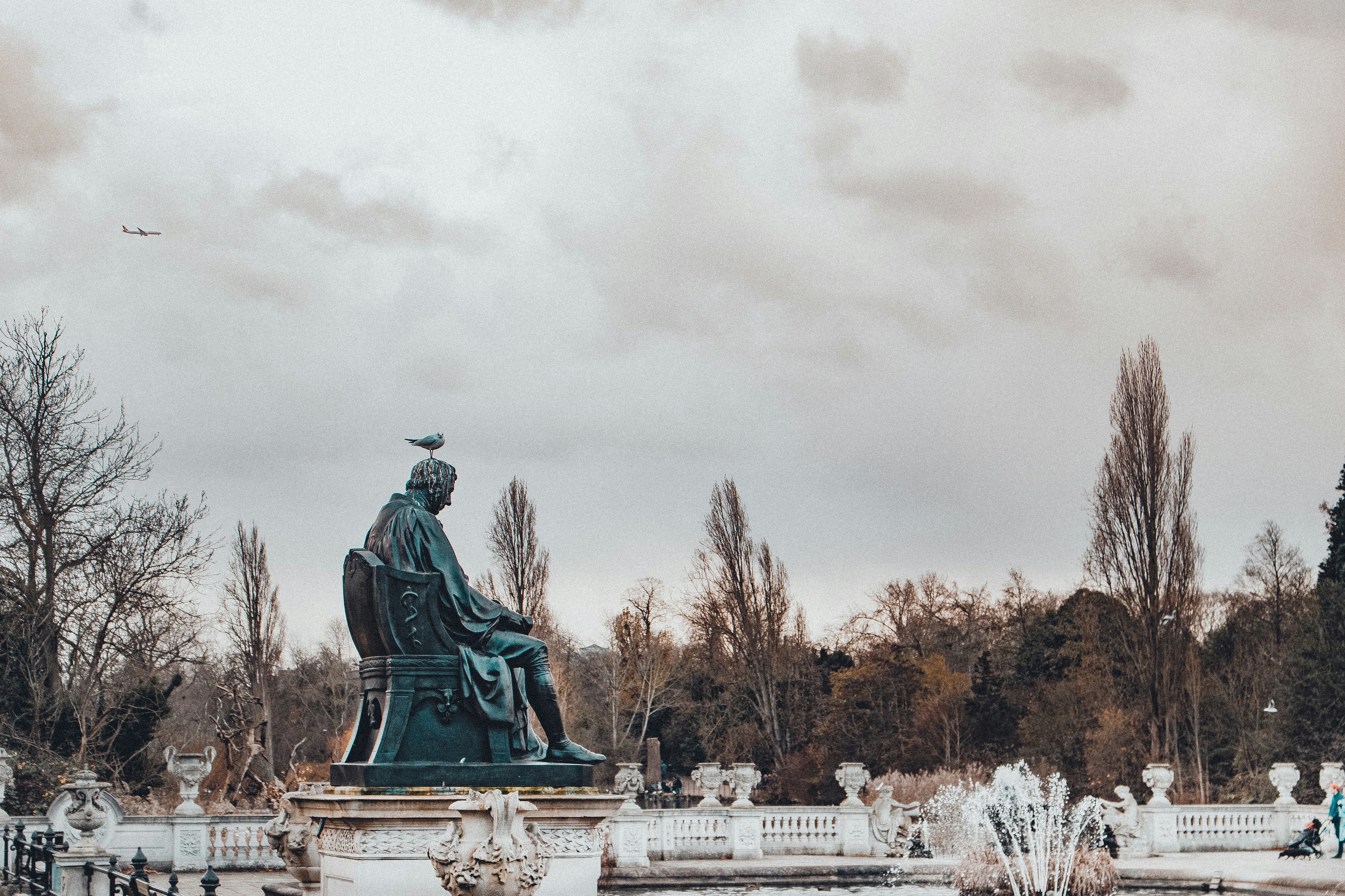 concrete statue of man sitting