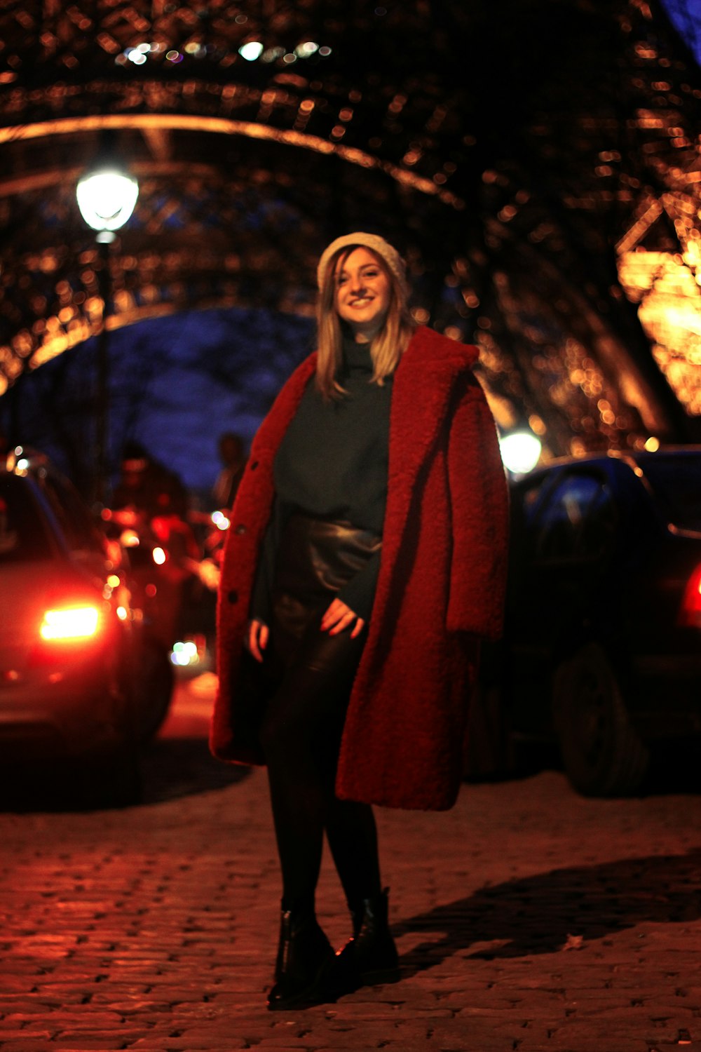 woman in red coat standing near Eiffel Tower