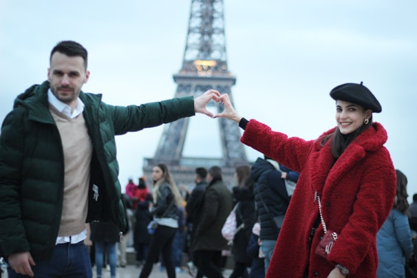 A happy family posing in front of the Eiffel Tower during their European tour arranged by European Traveler.