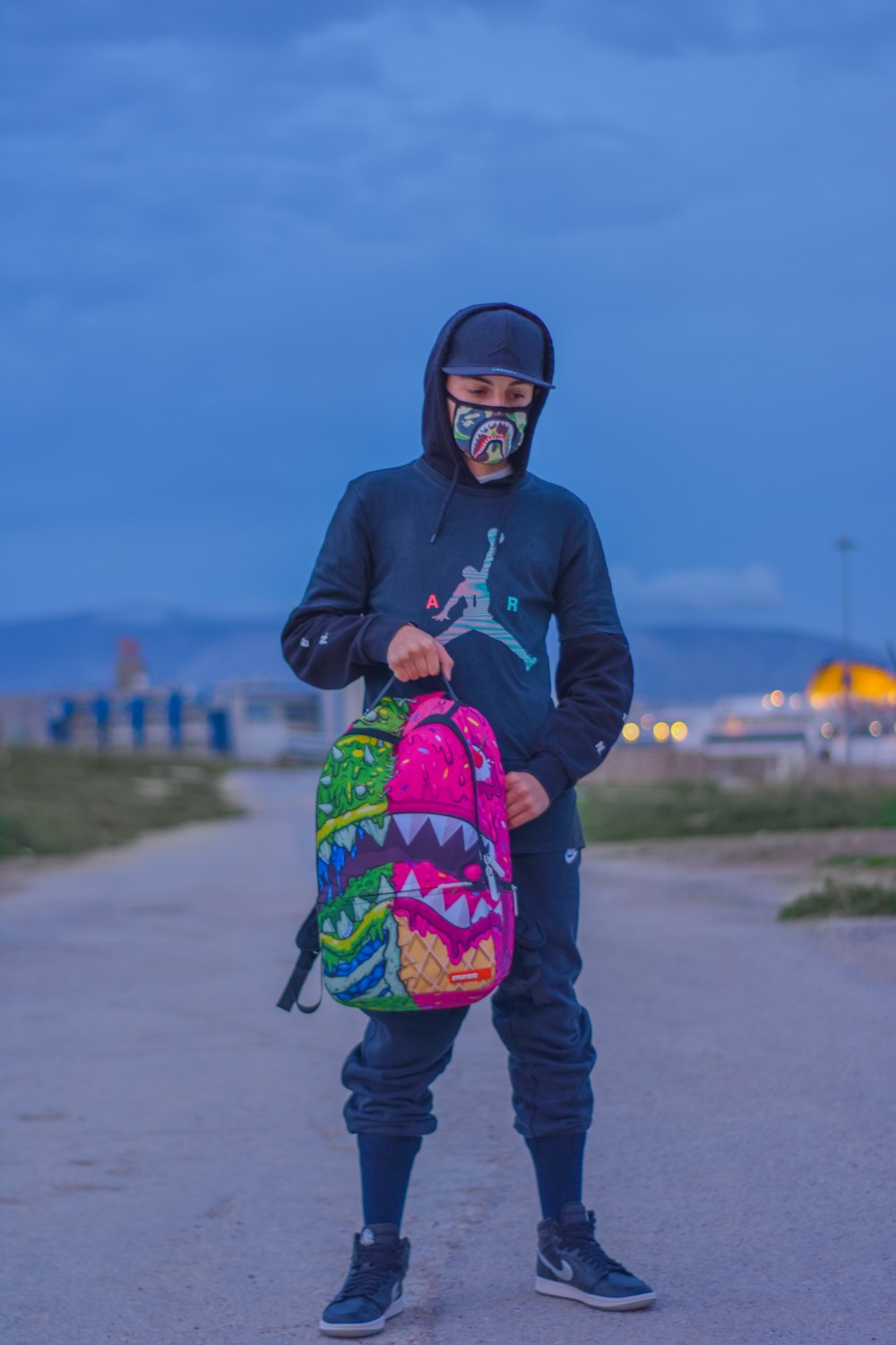 man in gray jacket with backpack