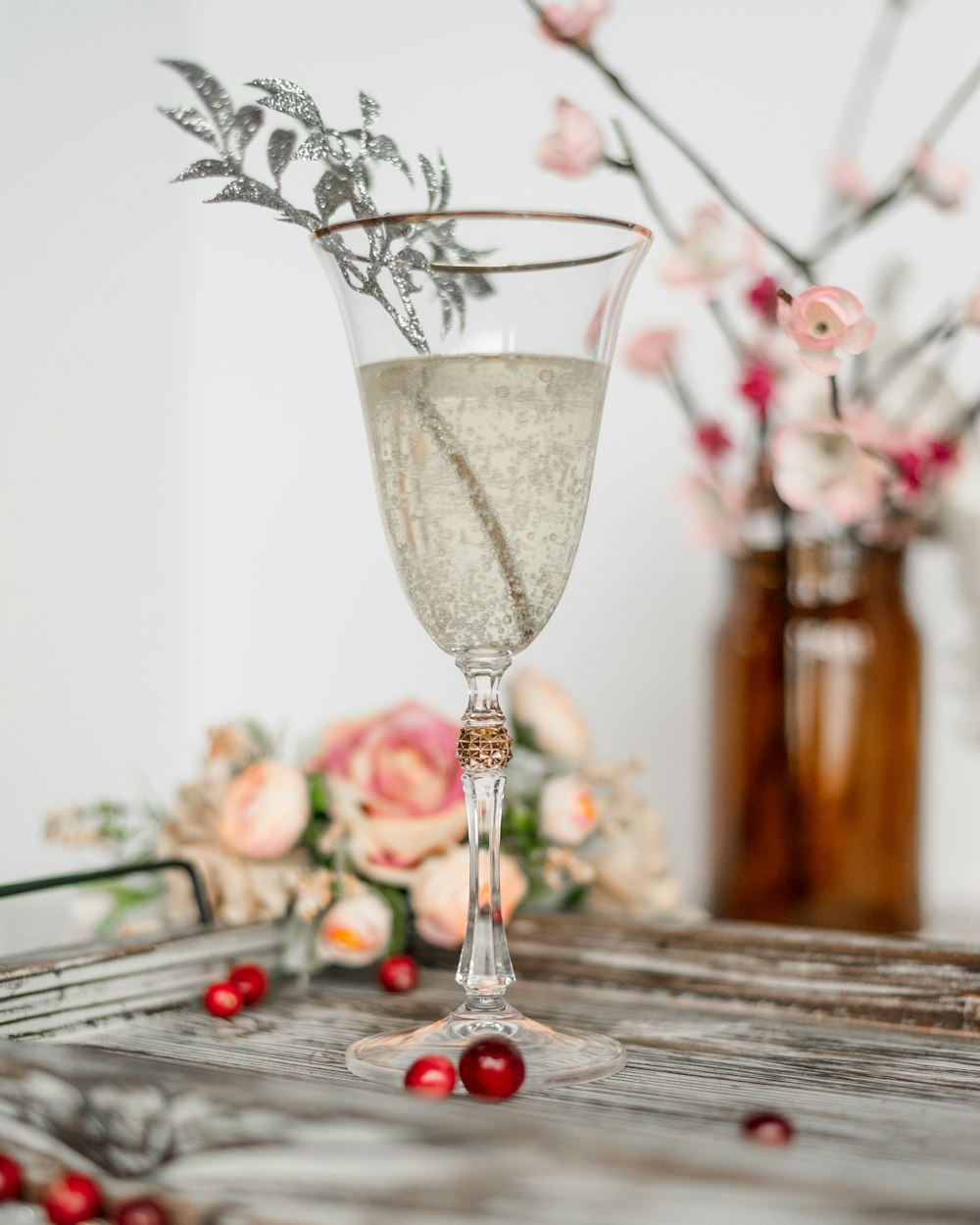 footed glass cup on wooden tray