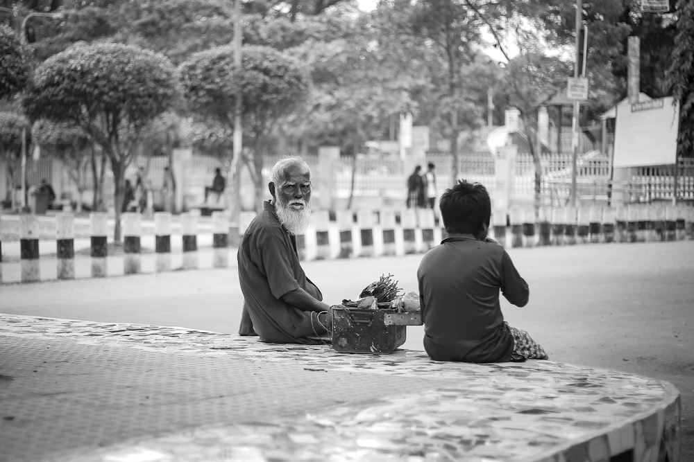 man sitting beside the boy