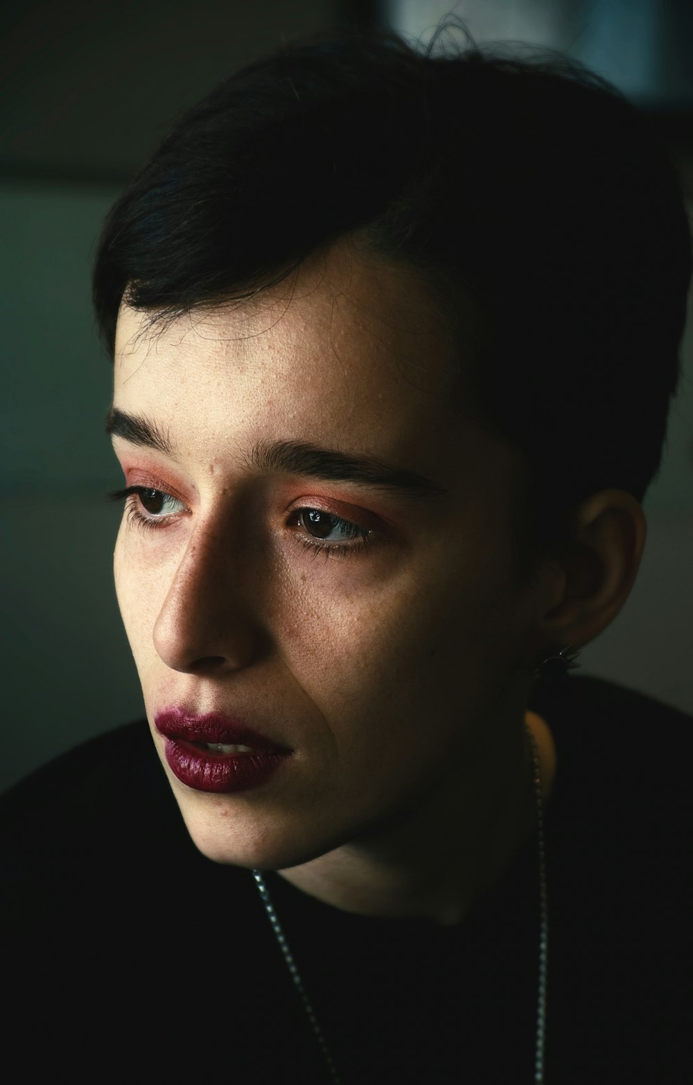 a close up of a person wearing a necklace