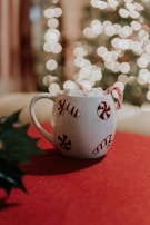 Personalized mugs with candy decorations.
