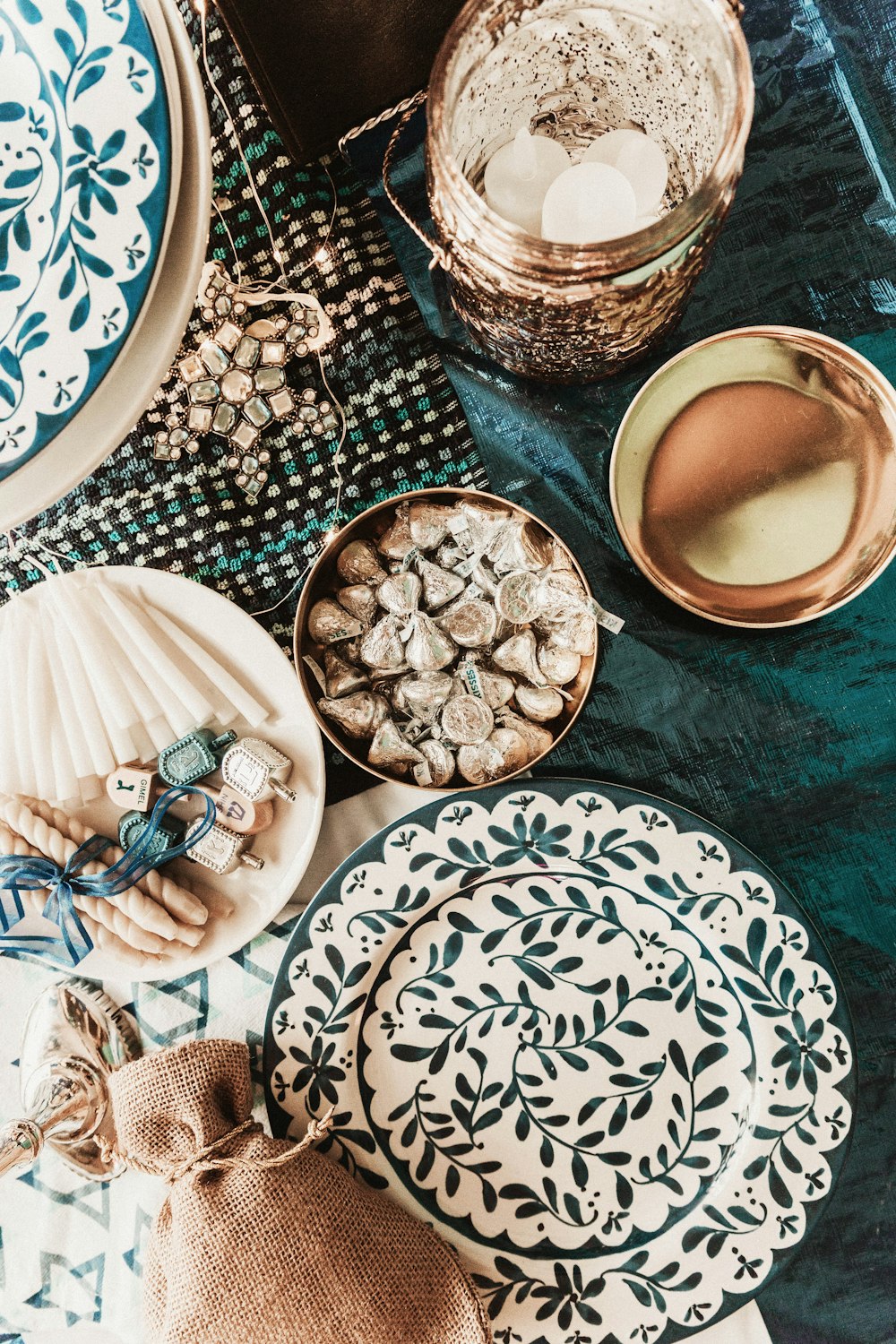 a table topped with plates and bowls of food