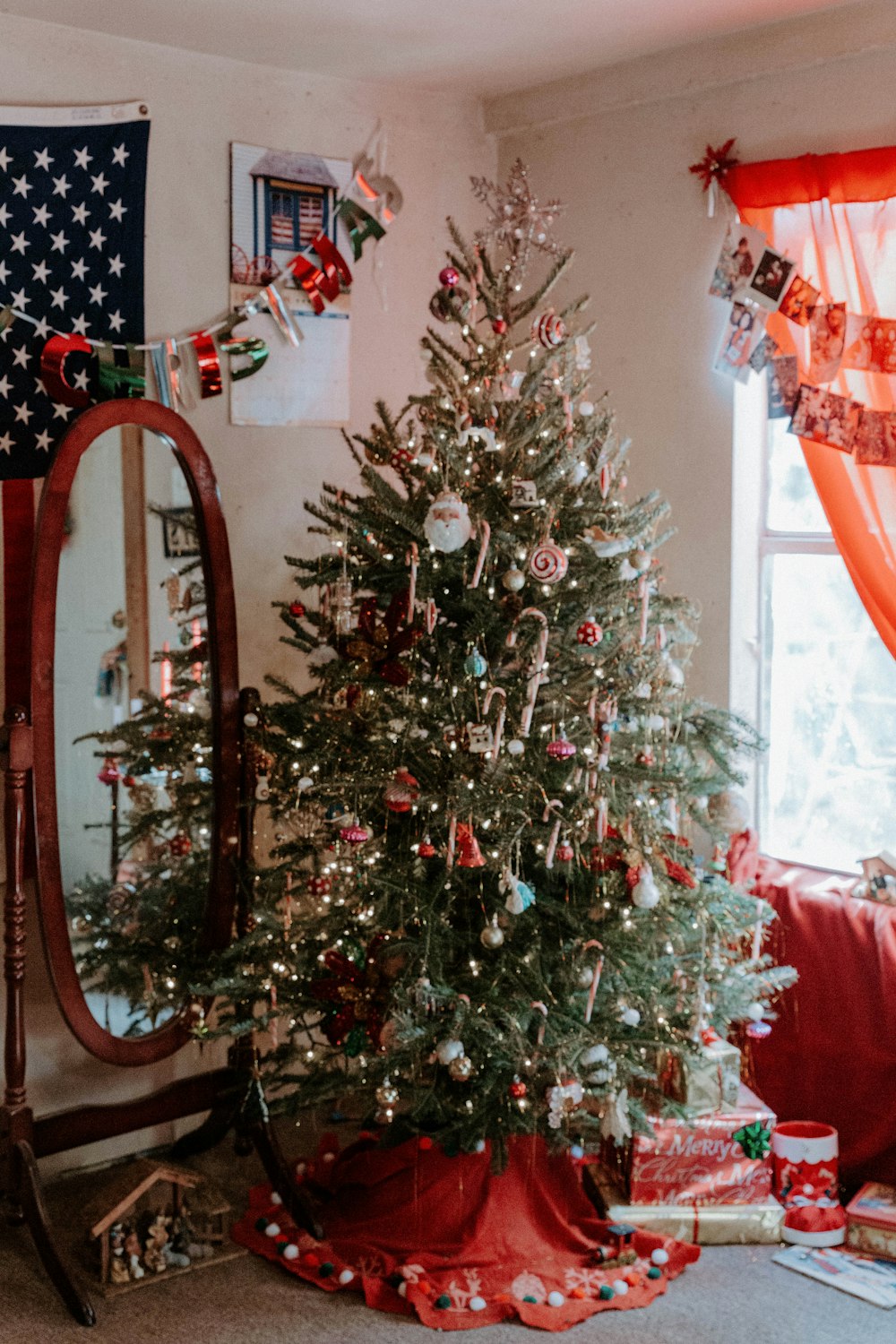 Christmas tree beside cheval mirror