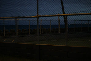 Evening shot of a fenced area with gentle lighting highlighting the clean finishing and level ground