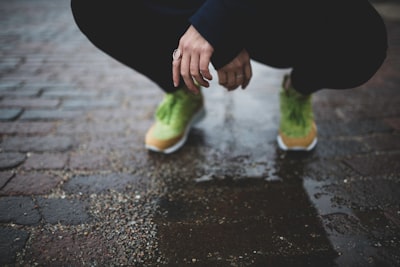 person squatting on brick road during day kansas google meet background