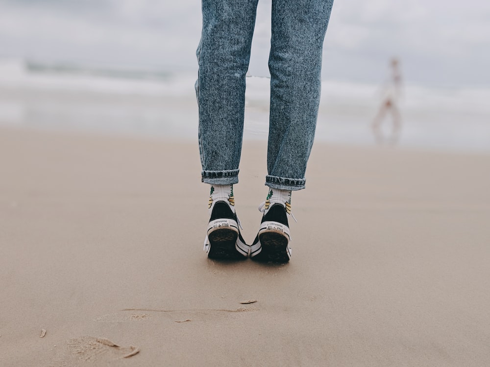 person wearing black low-top sneakers