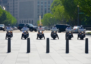 six men riding motorcycles