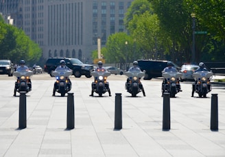 six men riding motorcycles