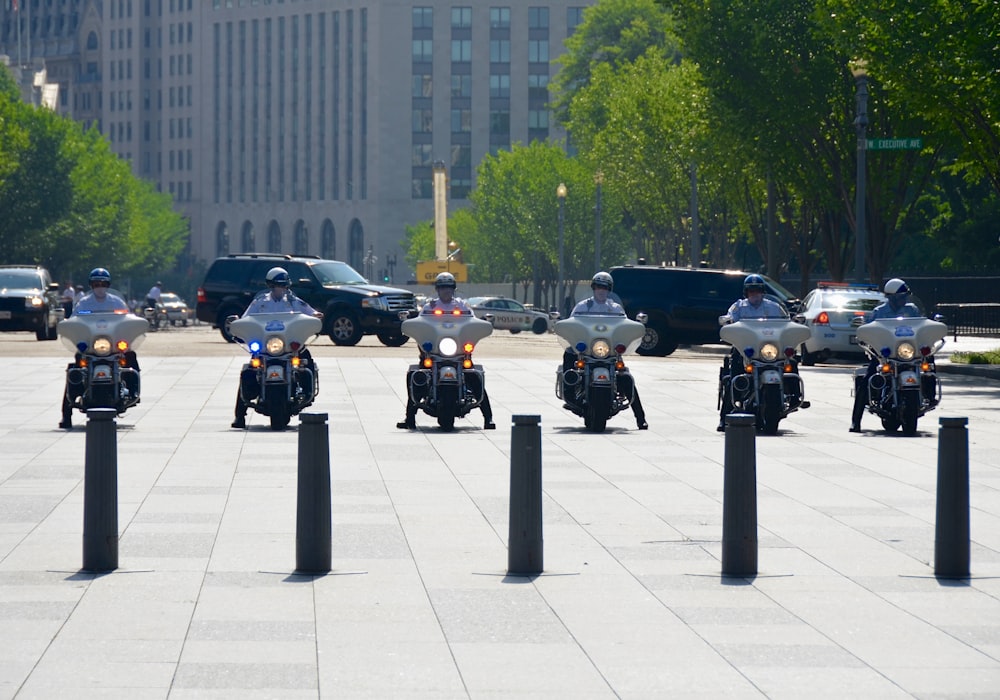 six men riding motorcycles