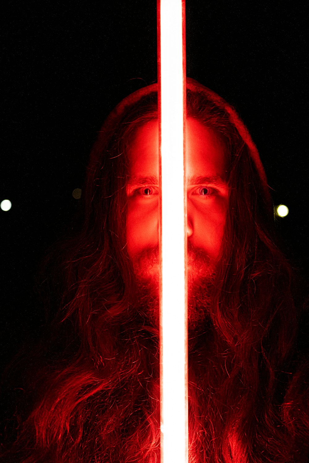 man holding red lightsaber