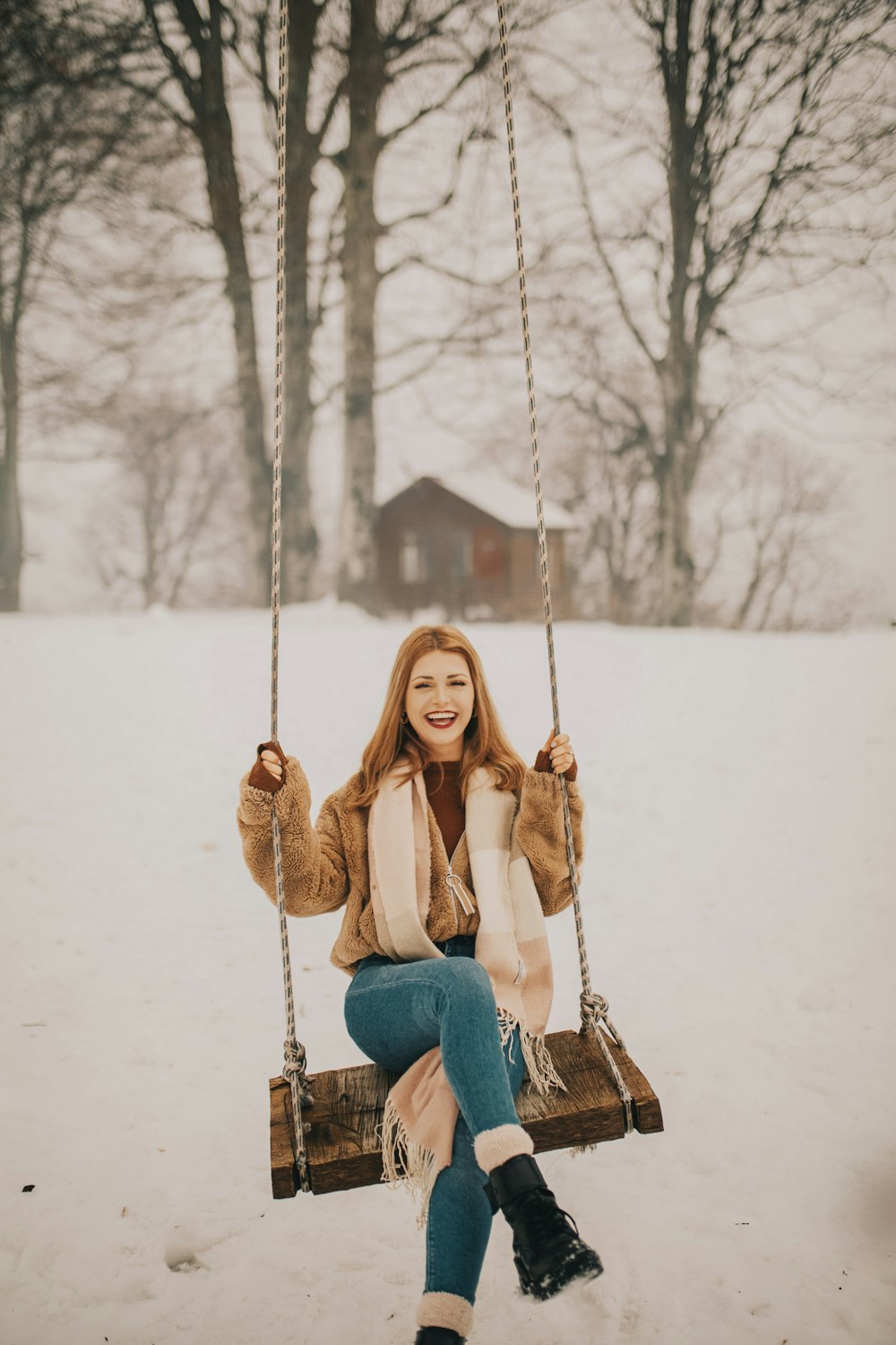 woman riding on swing outdoors