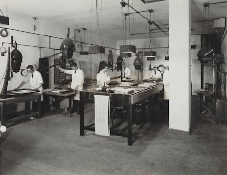 three persons standing beside table