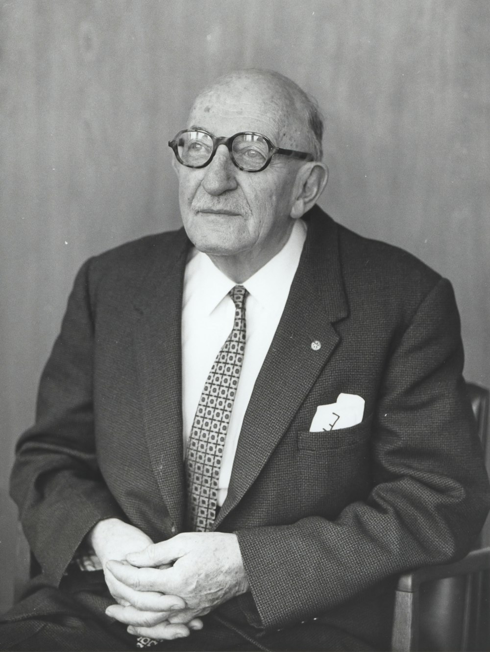 man wearing suit jacket and eyeglasses