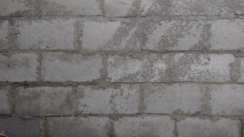 Close-up of brick wall with fresh mortar applied.