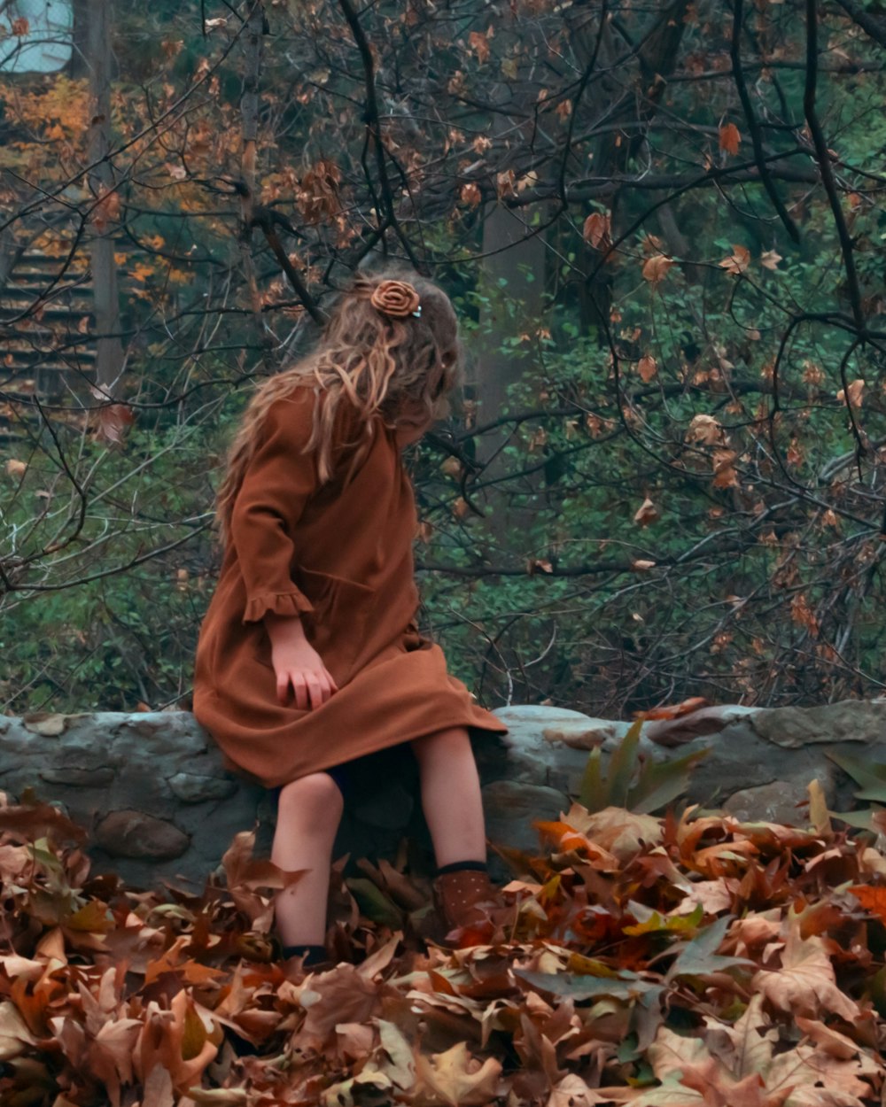 girl sitting on rock