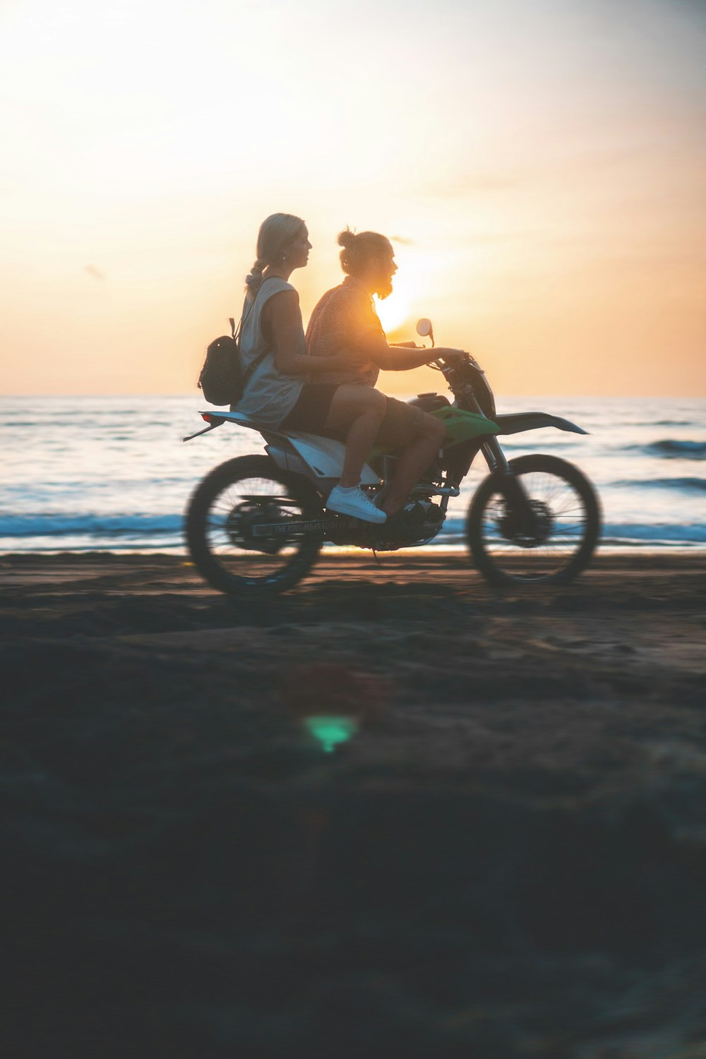 man and woman riding on motorcycle